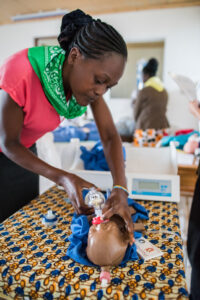 Woman working with a simulation baby