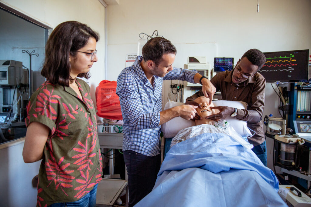 UCSF's Tyler Law, MD, works with William Booth, MD, at Mbale Hospital, Uganda.