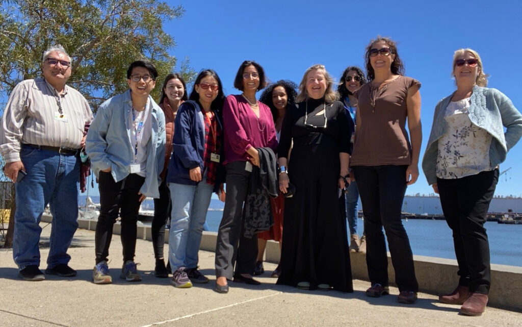 Group of IGHS employees standing in front of the bay for a portrait