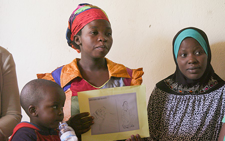 Woman holding a picture that her child drew