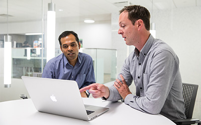 Vikram Sridharan (left) works with his capstone research mentor,
Hugh Sturrock, IGHS faculty and lead researcher for DiSARM